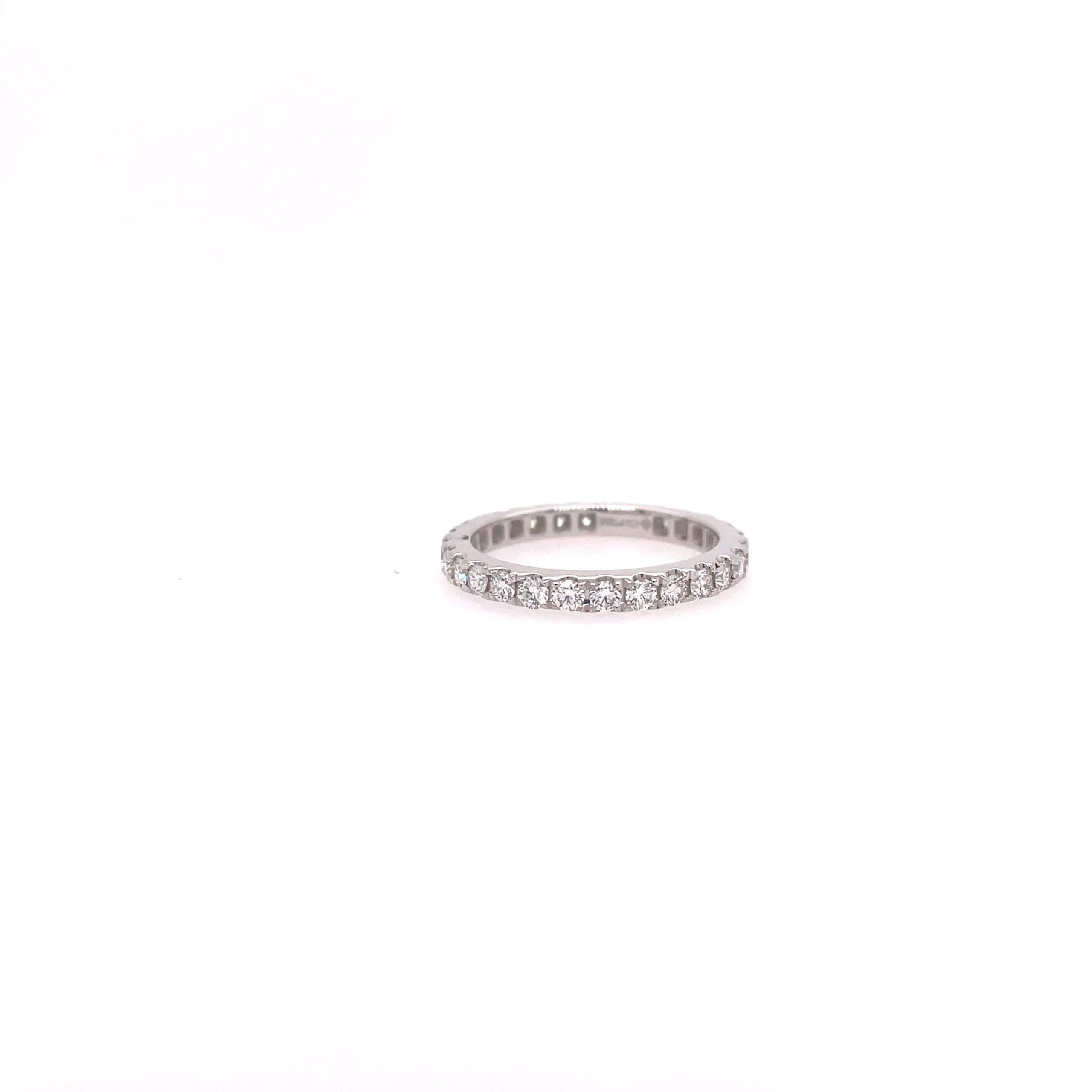 One white gold ring, the band filled with pave set round cut diamond, set againts on a white background and surfaced.