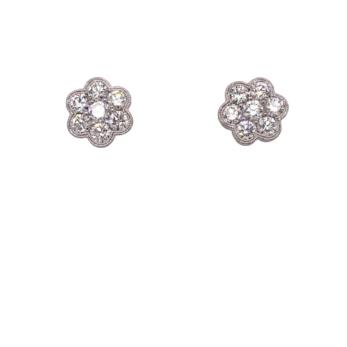 Two white gold stud earrings with seven round diamonds encrusted, it sets againts on a white background and directly facing the camera.