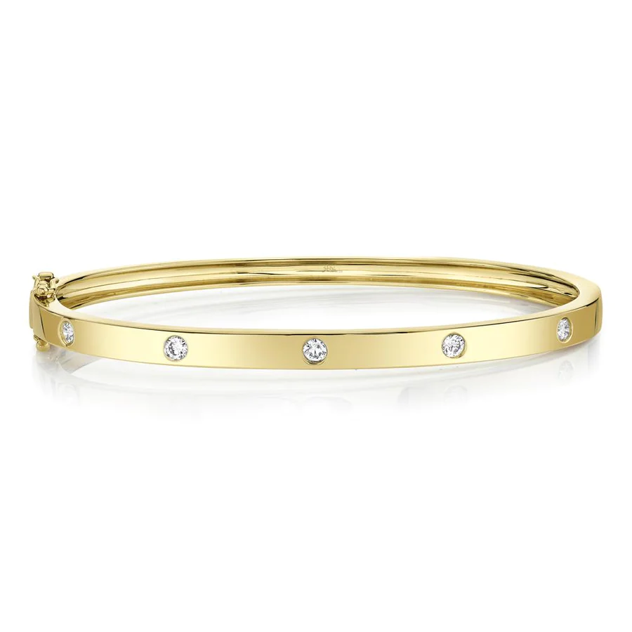 One yellow gold bangle placed on a white background directly facing the camera. The bangle adorned with round diamonds.