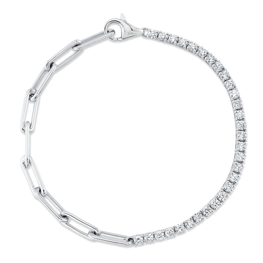One white gold bracelet, the bracelet shared a design with half paper link chain and half diamond tennis style, it is resting on a white surfaced and background.