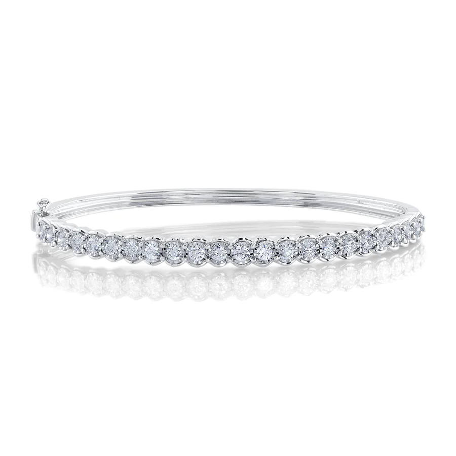 One white gold bracelet with a bezel set design, placed on a white background with a closed up shot.