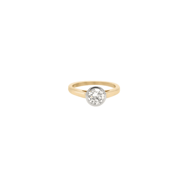 One yellow gold ring. The ring features a plated gold band with a round shaped single cut diamond.