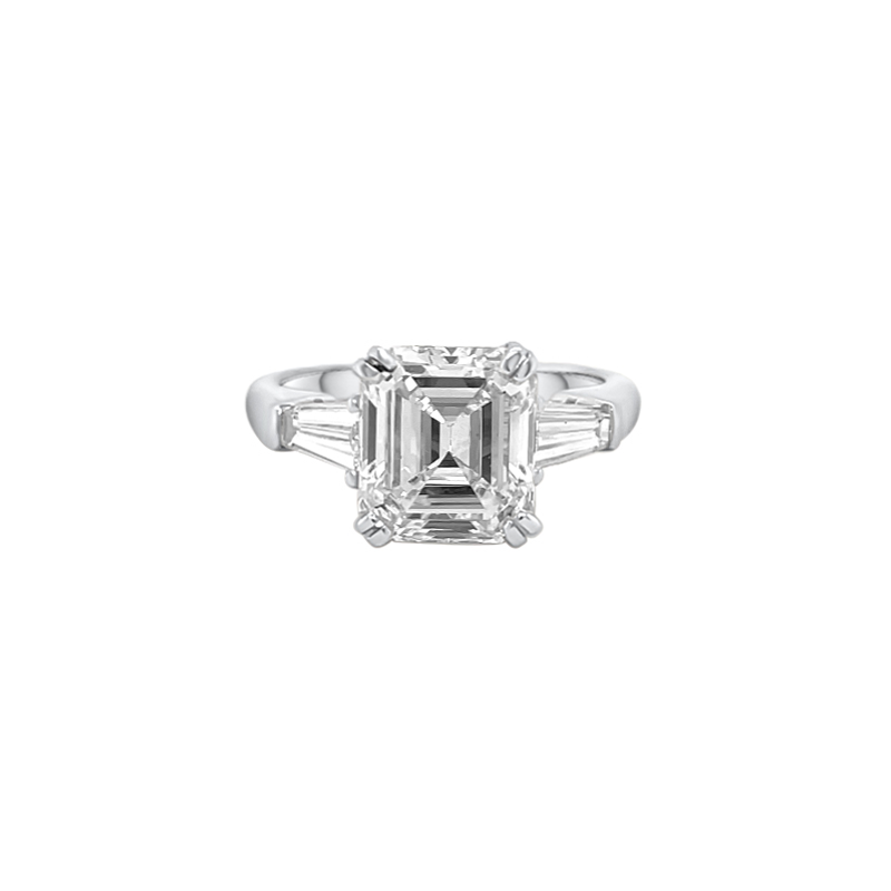 One white gold ring featuring two diamond accents between a center-mounted square-shaped diamond.