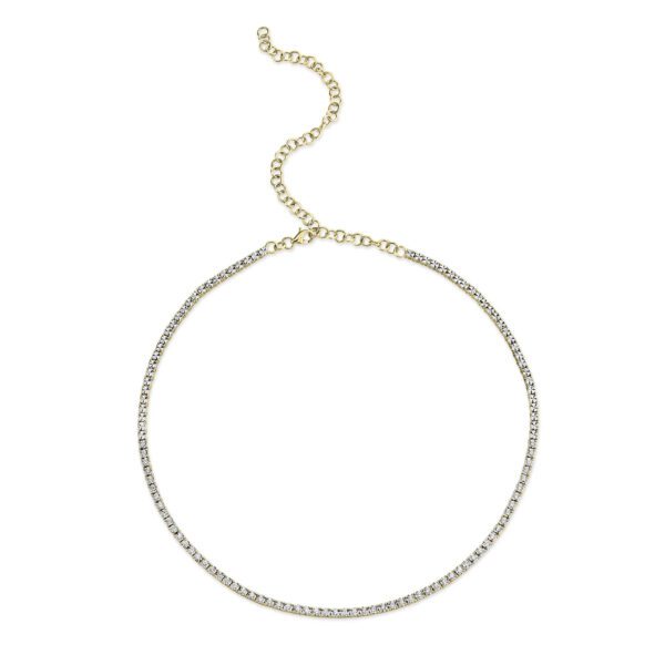 One yellow gold tennis necklace. The necklace adorned with diamonds are set in a continuous line.