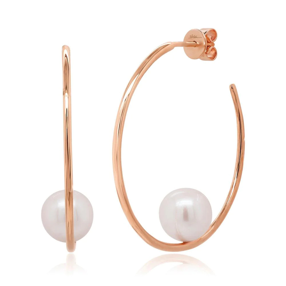 Two rose gold earrings with a hook-shaped design. The earrings feature a curved hook with a white pearl placed in the middle of the curve.