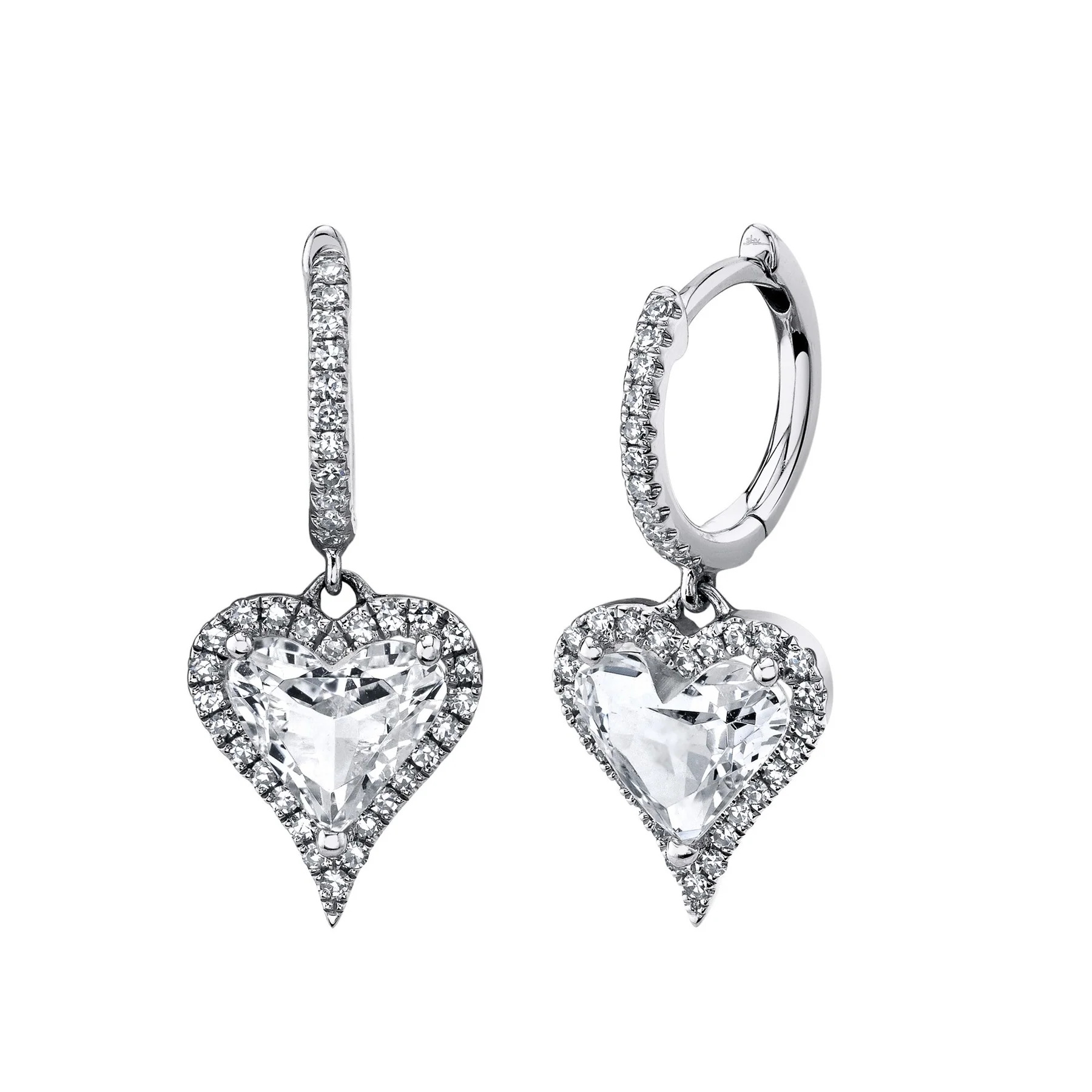 Two white gold earrings featuring a central heart shape with a white topaz gemstone and surrounded by diamonds. The heart-shaped pendant hangs from the earring band with diamonds.