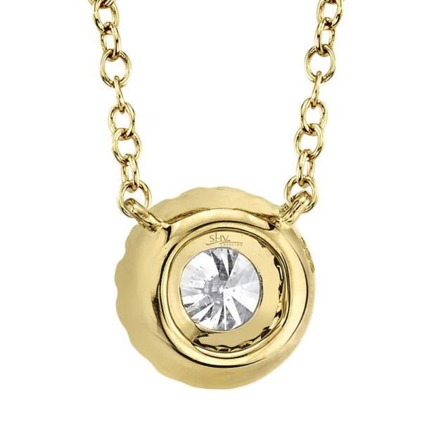 One yellow gold necklace with a round pendant. The pendant is facing away from the camera. The pendant on the back side has a small circular hole in the center, revealing the front side diamond of the necklace.