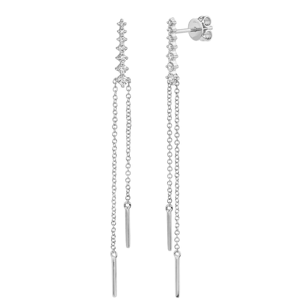 Two white gold earrings. The earrings feature seven diamonds with a thin chain and simple plated steel at the tip ends of the chain.
