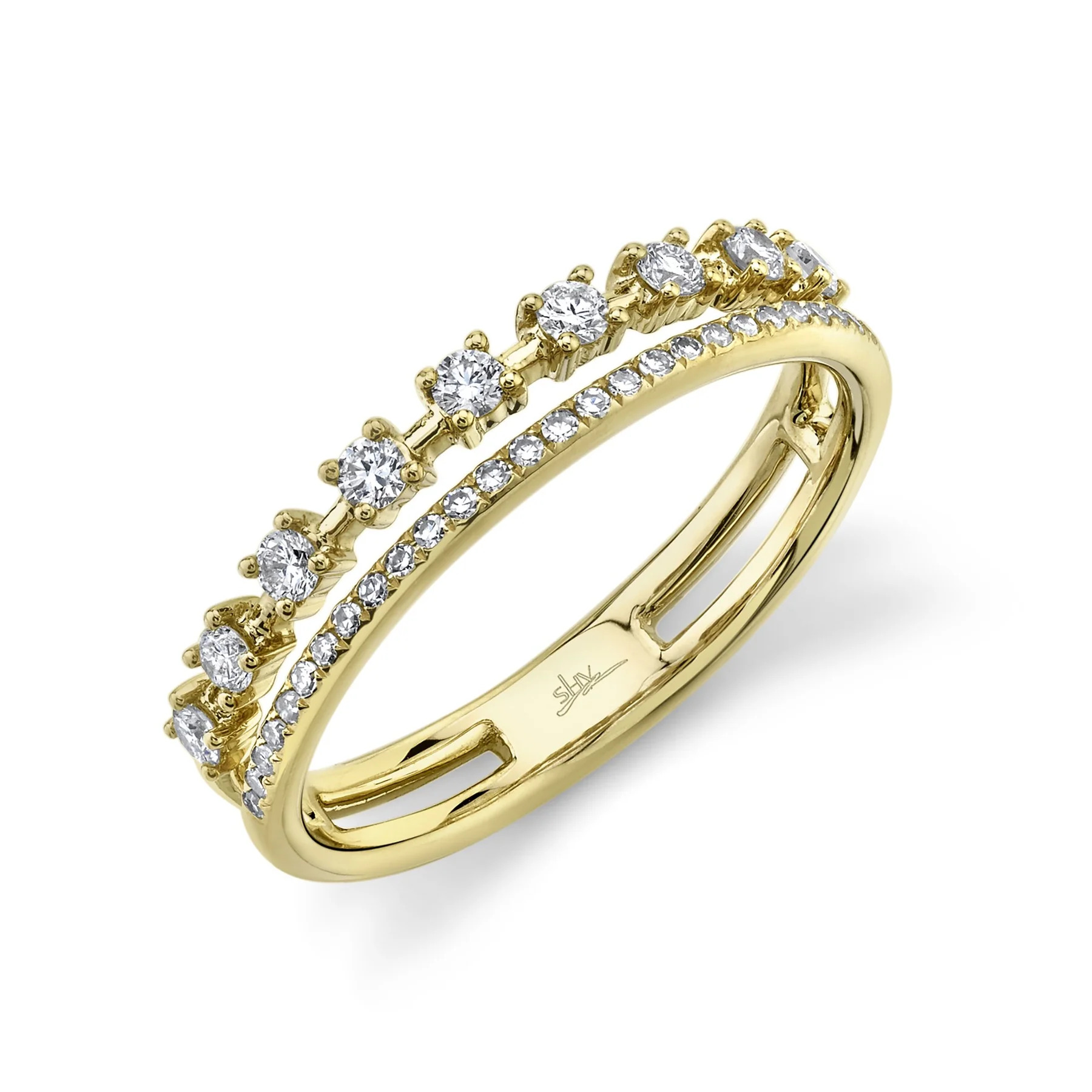 One yellow-gold ring is positioned slanted toward the camera. The ring showcases a double-row design, giving the illusion of two diamond bands. The first row features diamonds set in prongs, spaced out along the band. The second row of the ring is encrusted with diamonds.
