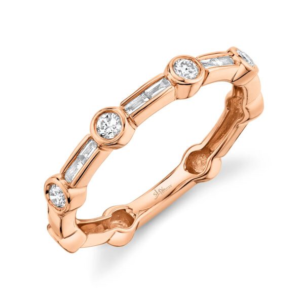 One rose gold ring slandted position toward the camera. The ring features with an alternating pattern of round and baguette diamonds.