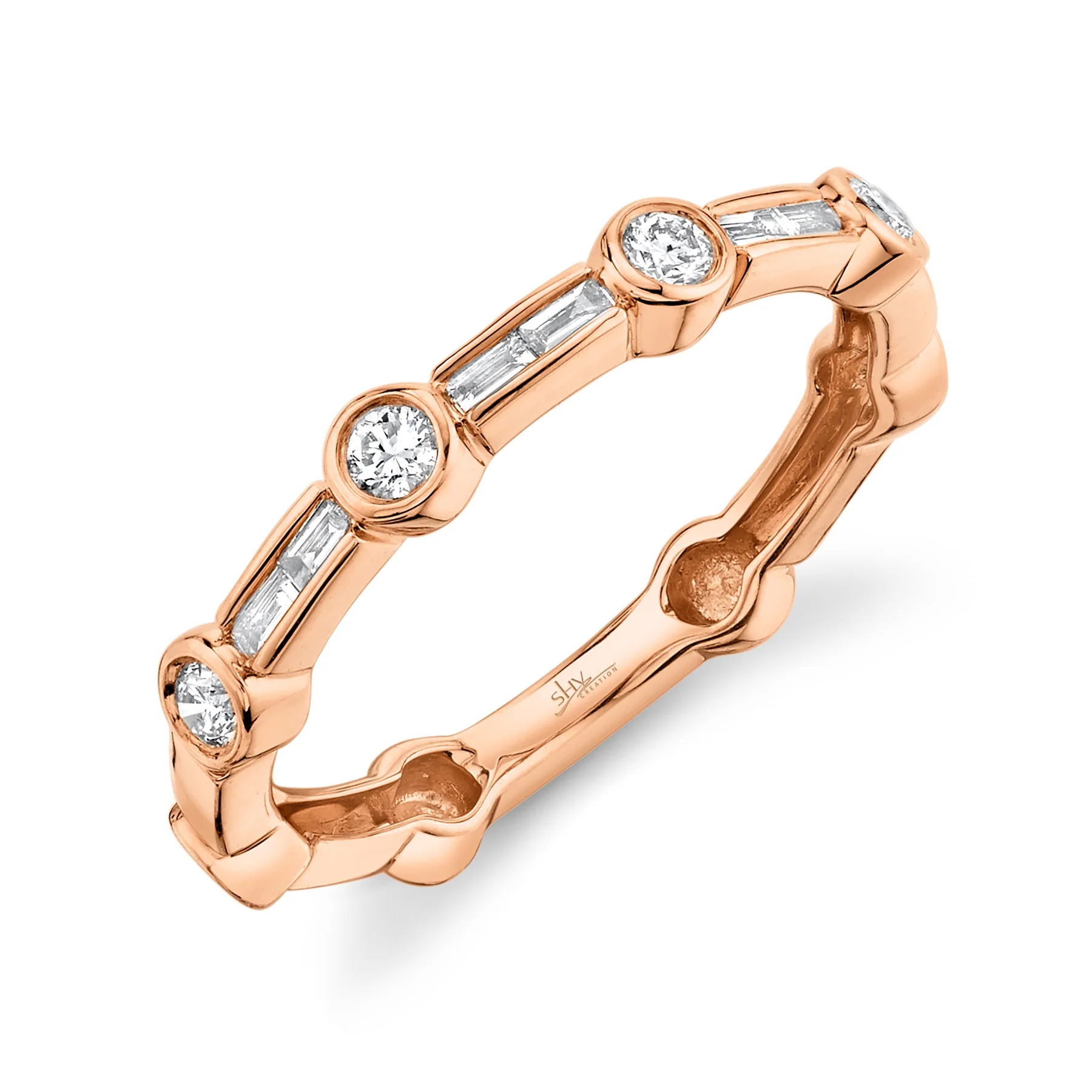 One rose gold ring slandted position toward the camera. The ring features with an alternating pattern of round and baguette diamonds.