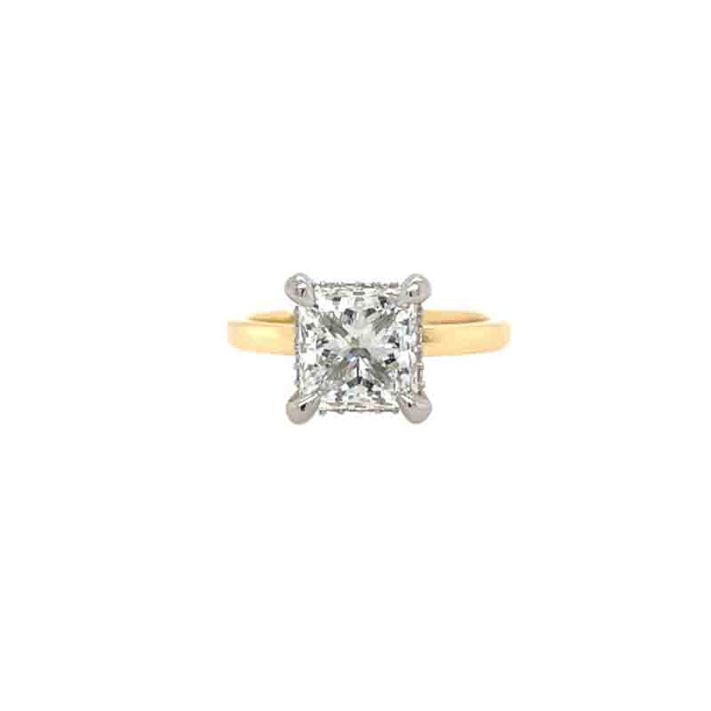 One combination colors of white ring in a prong set square shaped diamond with yellow gold band. The ring sets against a white background.