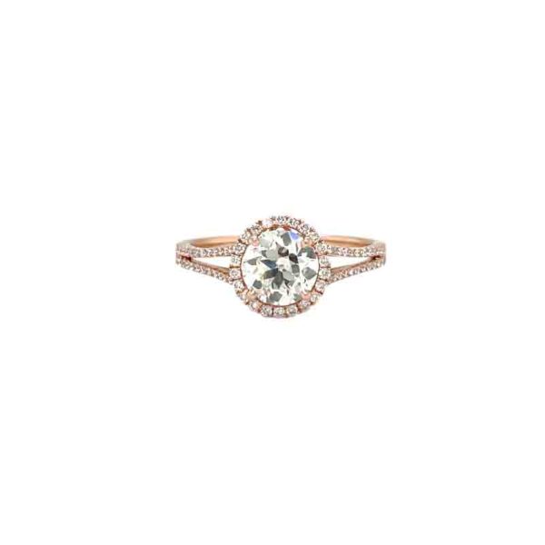 One rose gold ring featuring a split shank design filled with diamonds, the ring has mounted diamond as focal point of the piece held by a prong. Placed against a white background.